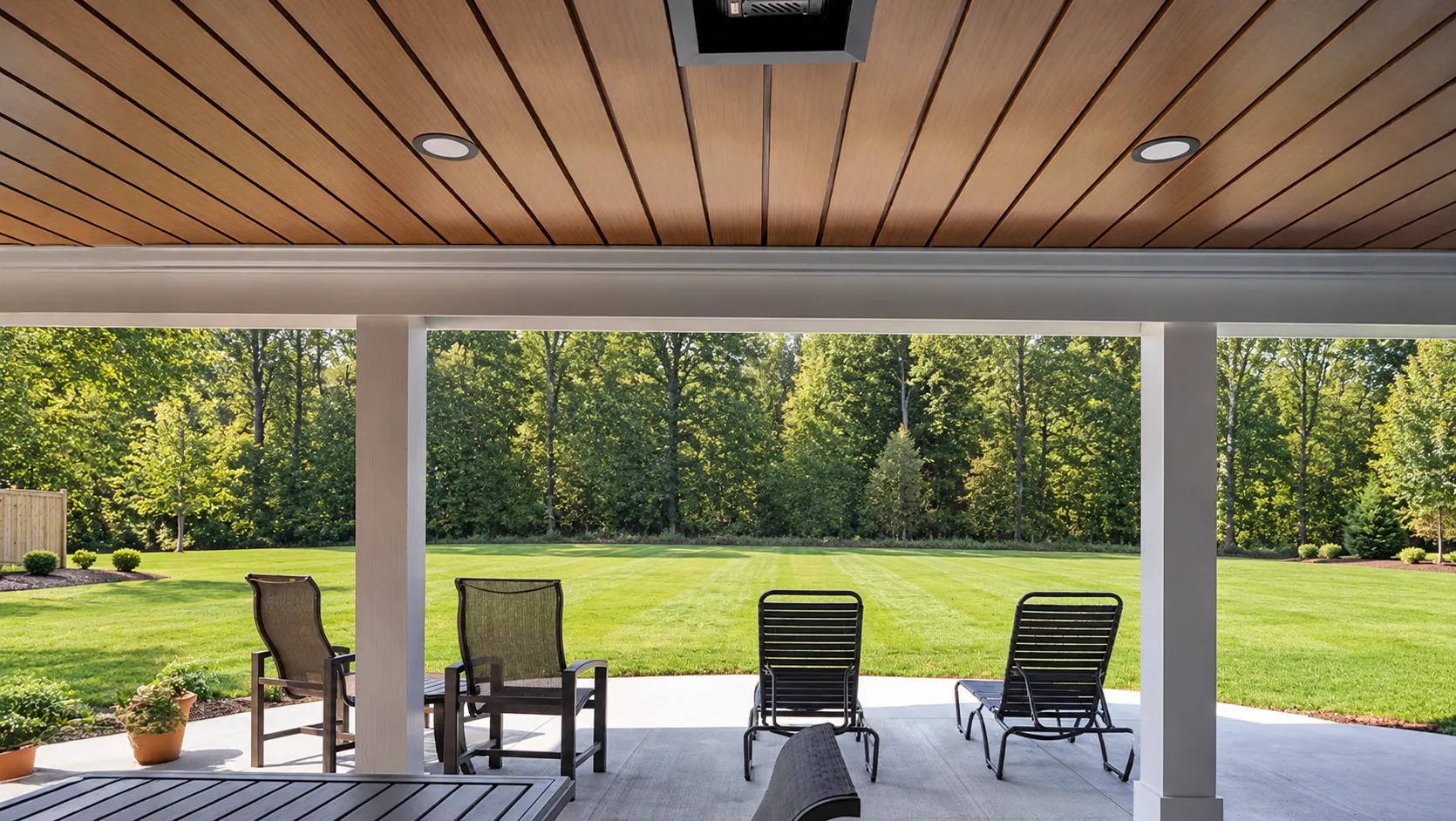 A finished under deck ceiling system over a dry, furnished patio